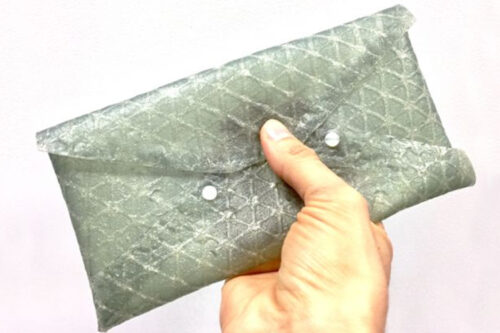 A small clutch purse demonstrates the utility of silk leather in manufacturing products