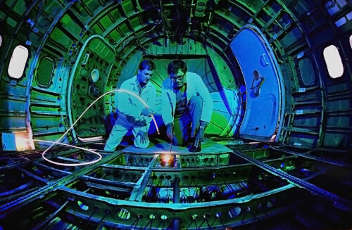 andia National Laboratories’ Dennis Roach, left, and Ken Harmon (retired) examine the inside of a Boeing 737 for long-term structural fatigue. Nondestructive techniques allow inspectors to assess the integrity of aircraft structures without disassembly. (Photo by Randy Montoya)