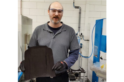 Application engineer Ward Steijn showing the first result of a thermopress cycle with snap-cure carbon fibre prepreg and Teccore TG180. Cycle time 7 minutes.