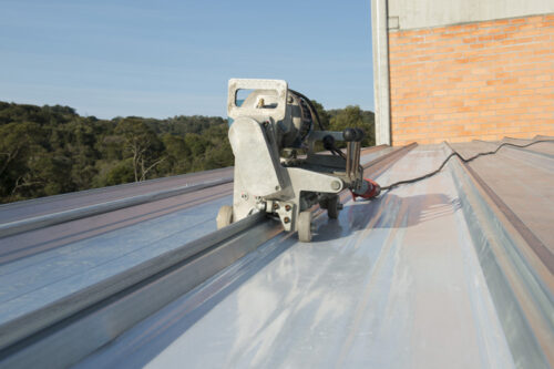 New technology avoids cutting metal roofing for the installation of composite tiles