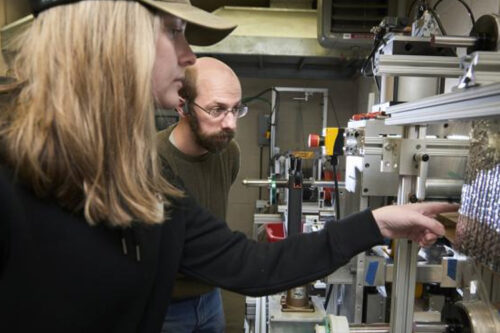 MSU junior Morgan Hogue, left, and research engineer Dan Schwendtner monitor a carbon fiber stretching machine in Doug Cairn’s lab on Nov. 9, 2022. MSU photo by Colter Peterson